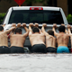 People push a stalled pickup through a flooded street in Houston on Aug. 27.